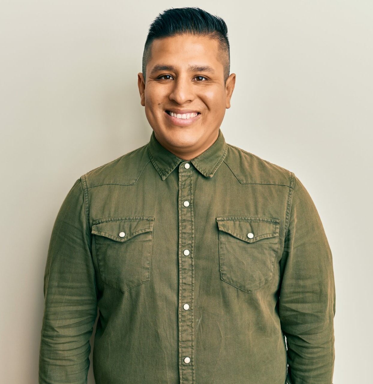 Young latin man wearing casual clothes with a happy and cool smile on face. lucky person.